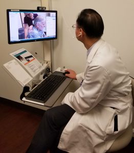 Doctor viewing a video of a patient