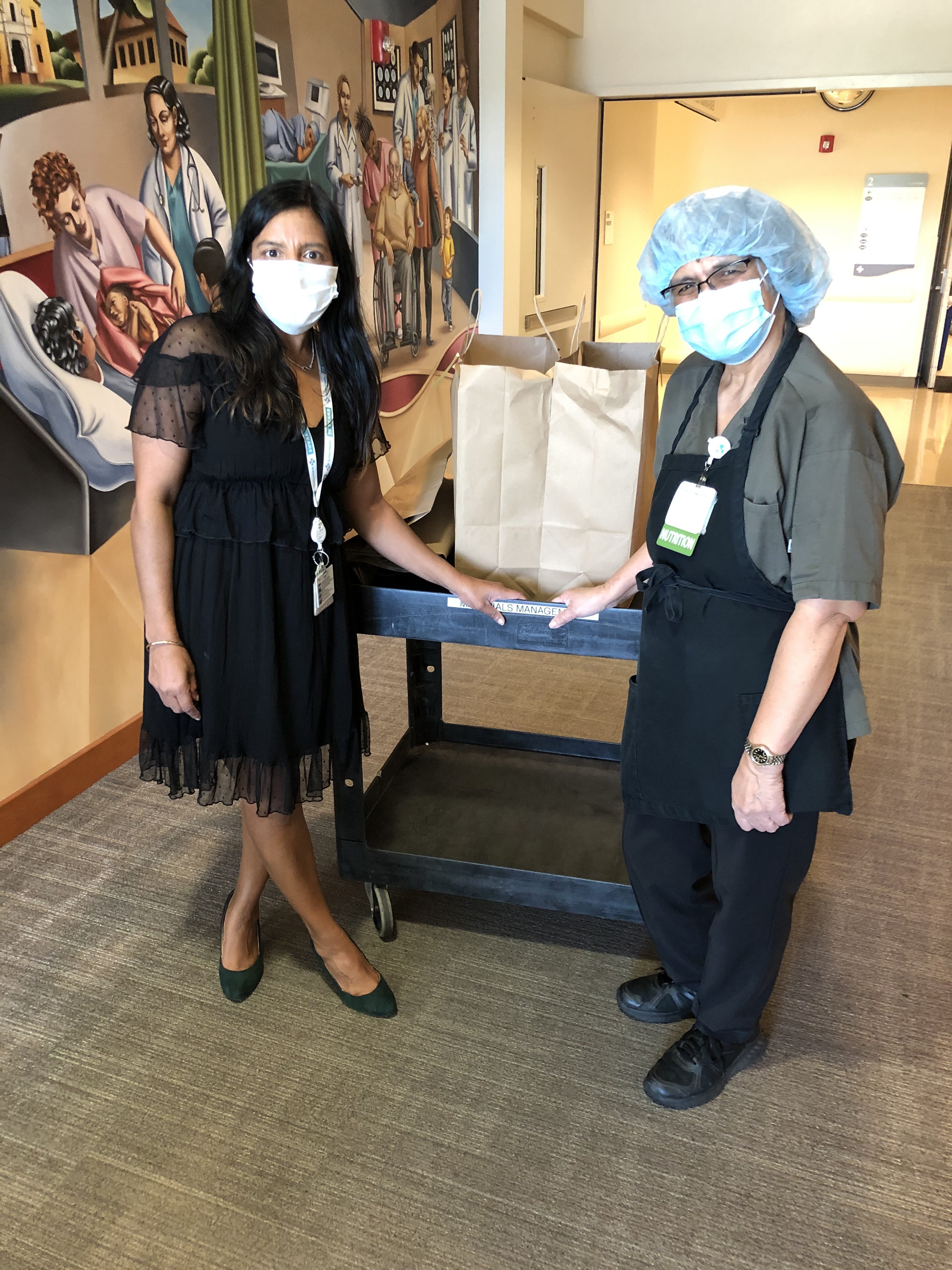 Loren Lafon (R) stands with the 200 meals she donated to Sutter Santa Rosa Regional Hospital amid the COVID-19 pandemic.