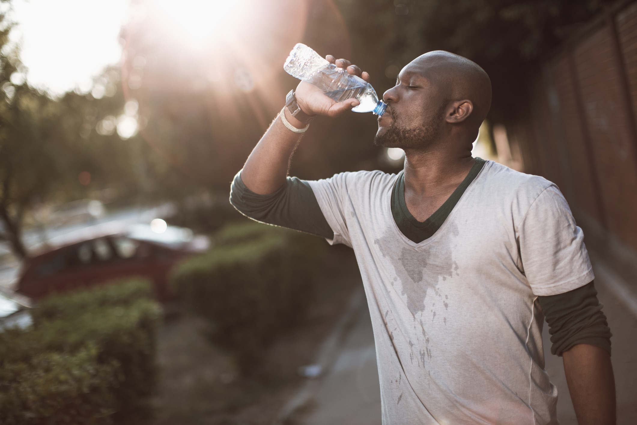 Picture of a young african-american man drinking water