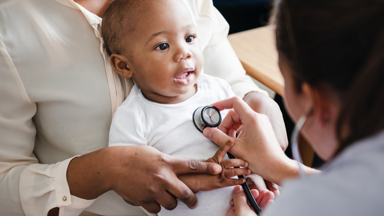 Small child and doctor checking his heart with a stethoscope