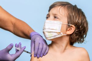 Little boy receiving his flu shot during pandemic times