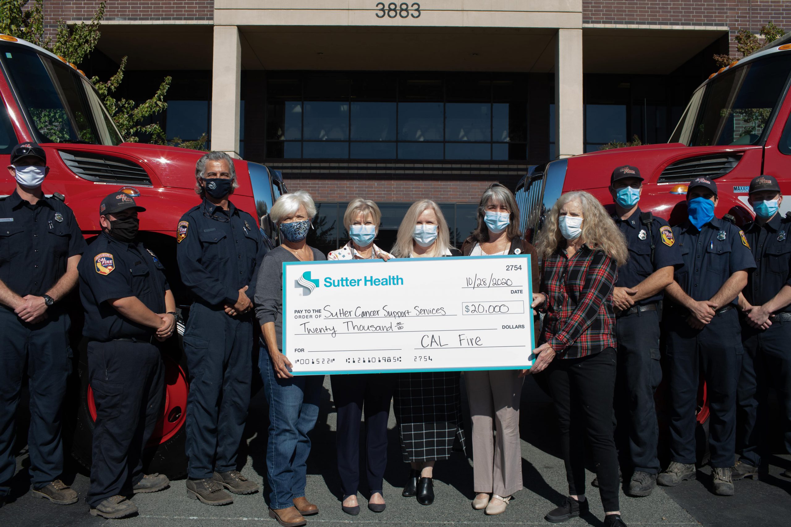 CalFire and Sutter Support Services pose together with $20,000 check