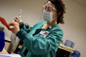 Lisa Gammon, RN, Novato Community Hospital, prepares to give Pfizer's COVID-19 vaccine on Dec. 17, 2020. 