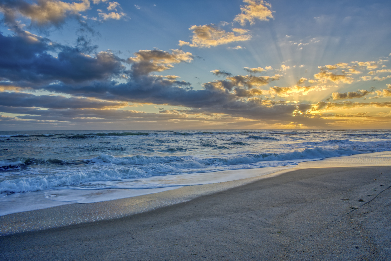 Sun reflecting on clouds at the beach