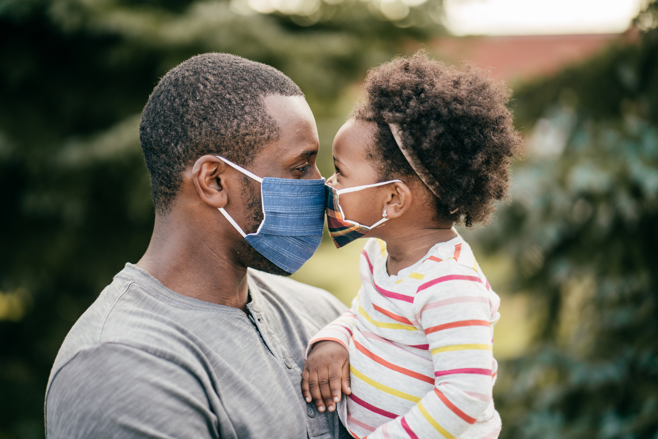 Father and toddler wearing mask outdoor