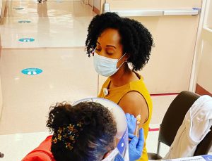 Black woman getting flu shot