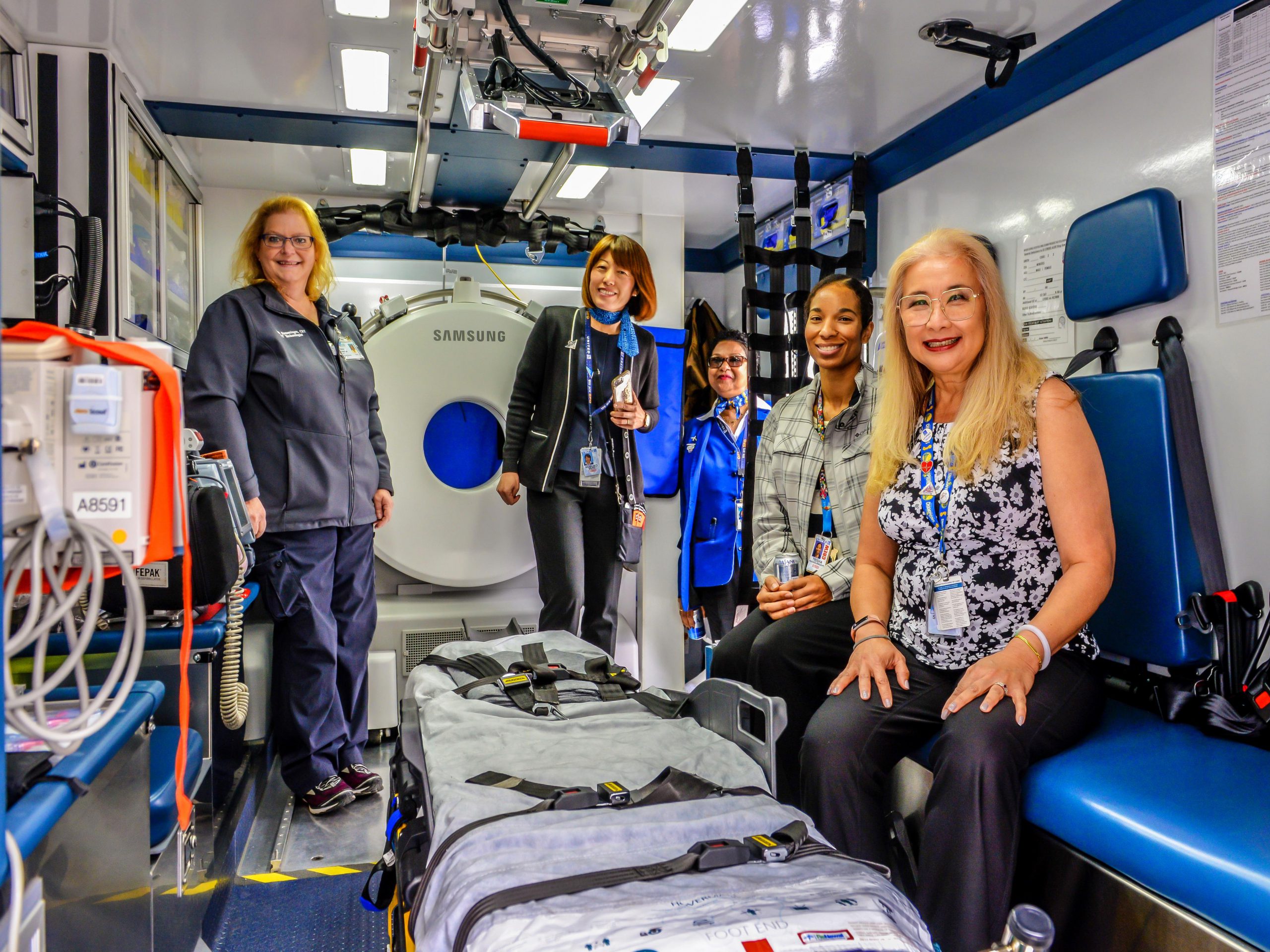 Nurses inside mobile stroke unit with CT scanner