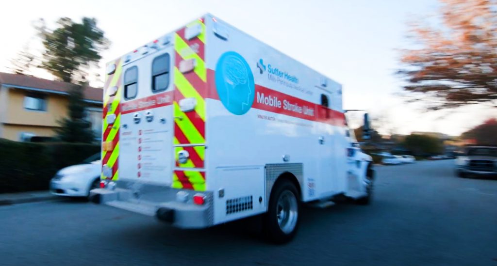 Specialized ambulance labeled mobile stroke unit races down street