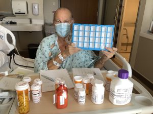 Man with medications and pill case