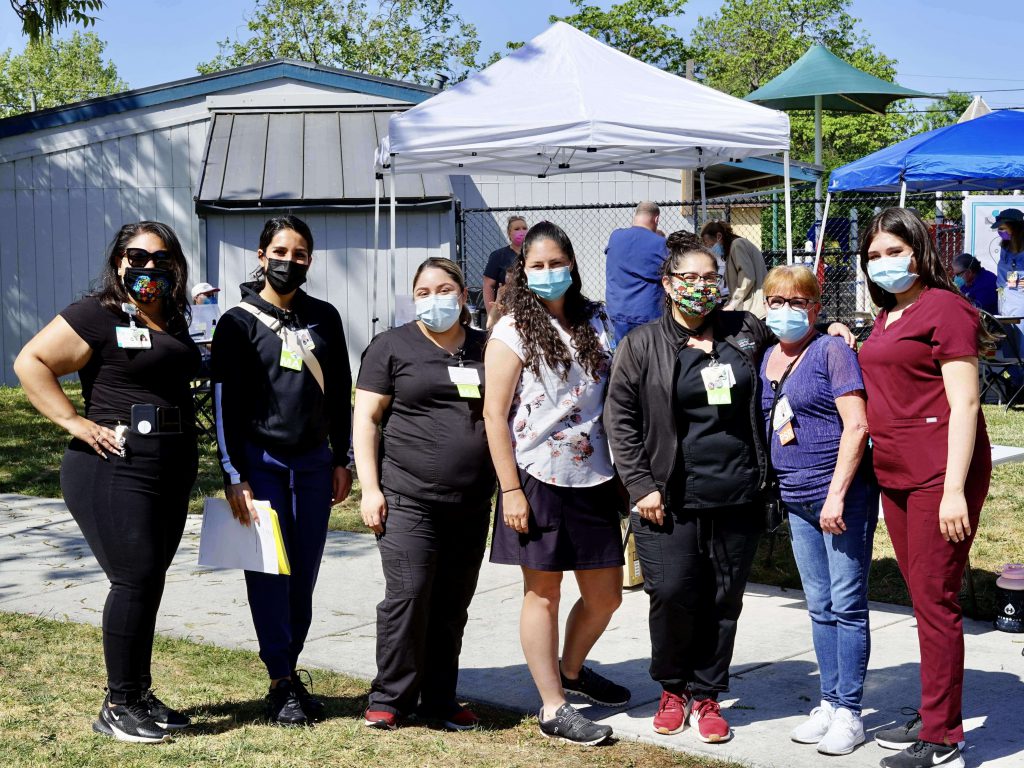 A handful of Sutter Health medical volunteers pose for a photo at a recent vaccine pop up clinic in Santa Rosa, California