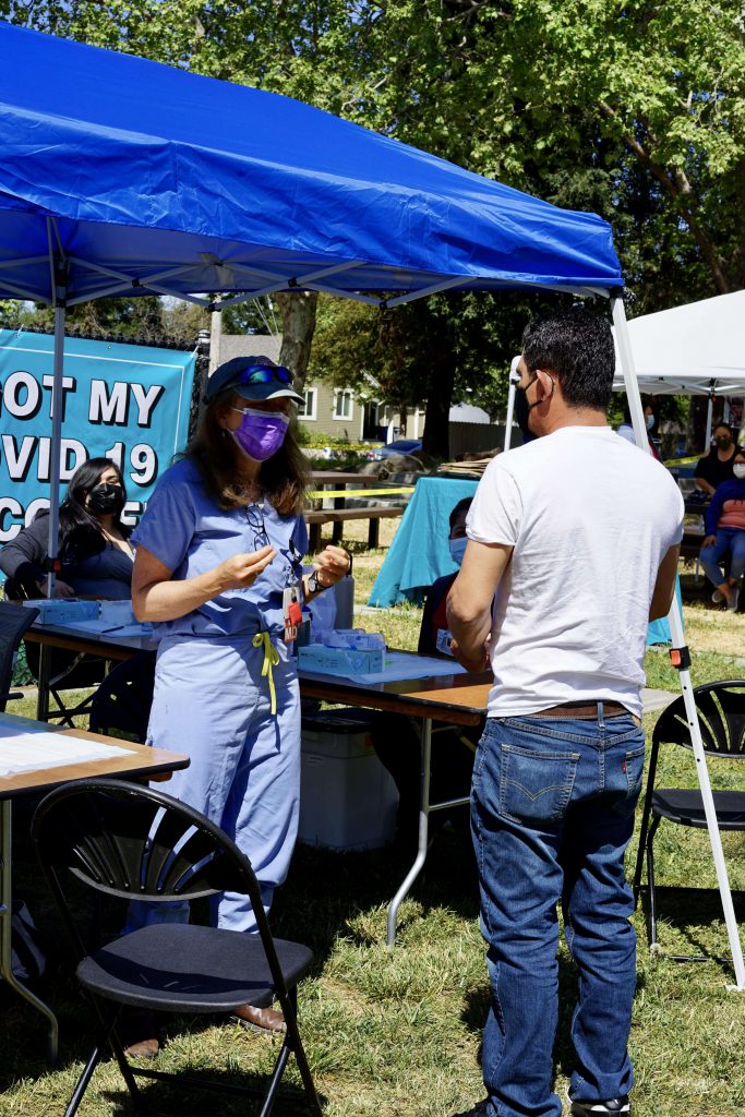 A Latino man listens to post-care instructions after receiving the vaccine at a recent community pop up clinic in Santa Rosa, California