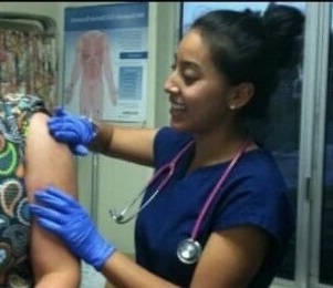 Photo of Rachel Valdez with a patient.