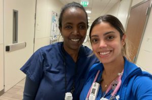 Yodit Mender, CNA, and Kayla Elias, RN, stand side by side at CPMC Van Ness Campus hospital where they now work together
