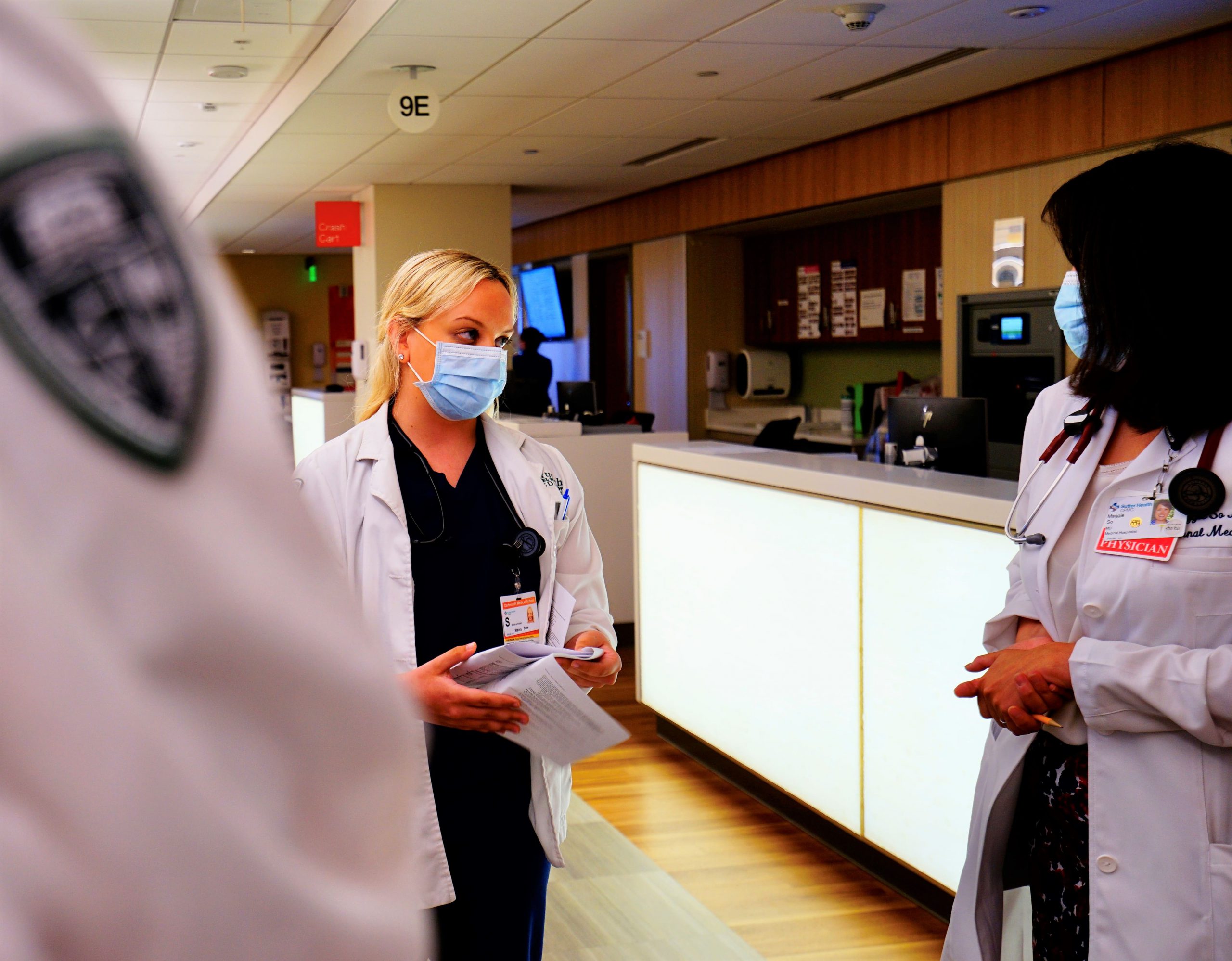 A young resident reviews a patient's care with the team