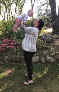 Sarah Heyl holding her first baby while pregnant with her second.