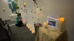 Chaplain Lila Hunt lights a candle for La Posada inside the chapel and spirtual center inside Sutter Medical Center, Sacramento.