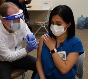 Cynthia Mendoza receiving her COVID vaccine.