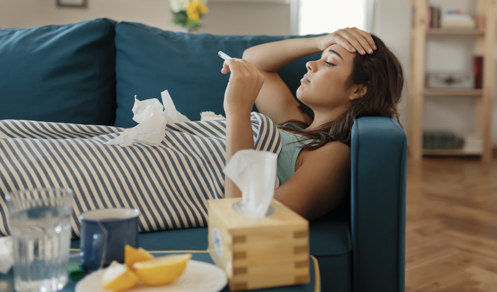 Sick woman lying on couch