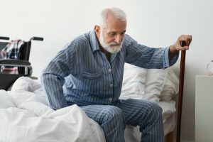 Man with cane struggling to get up