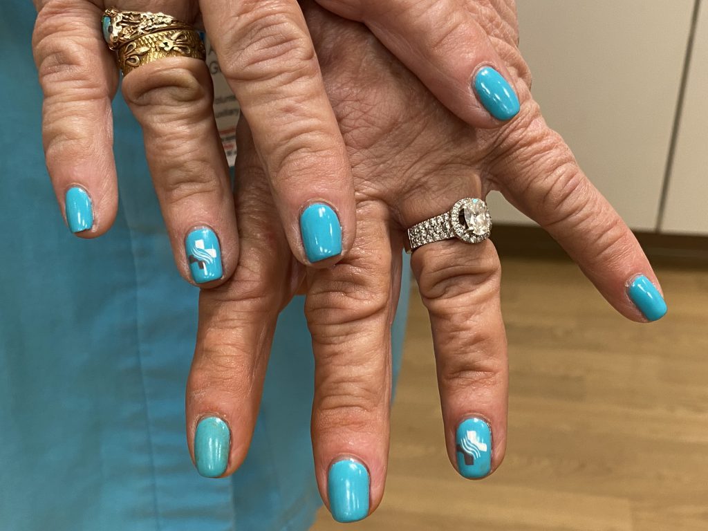 Sutter Health-themed painted fingernails: Alyce Glazer's fingernails feature her hospital's color scheme and logo.
