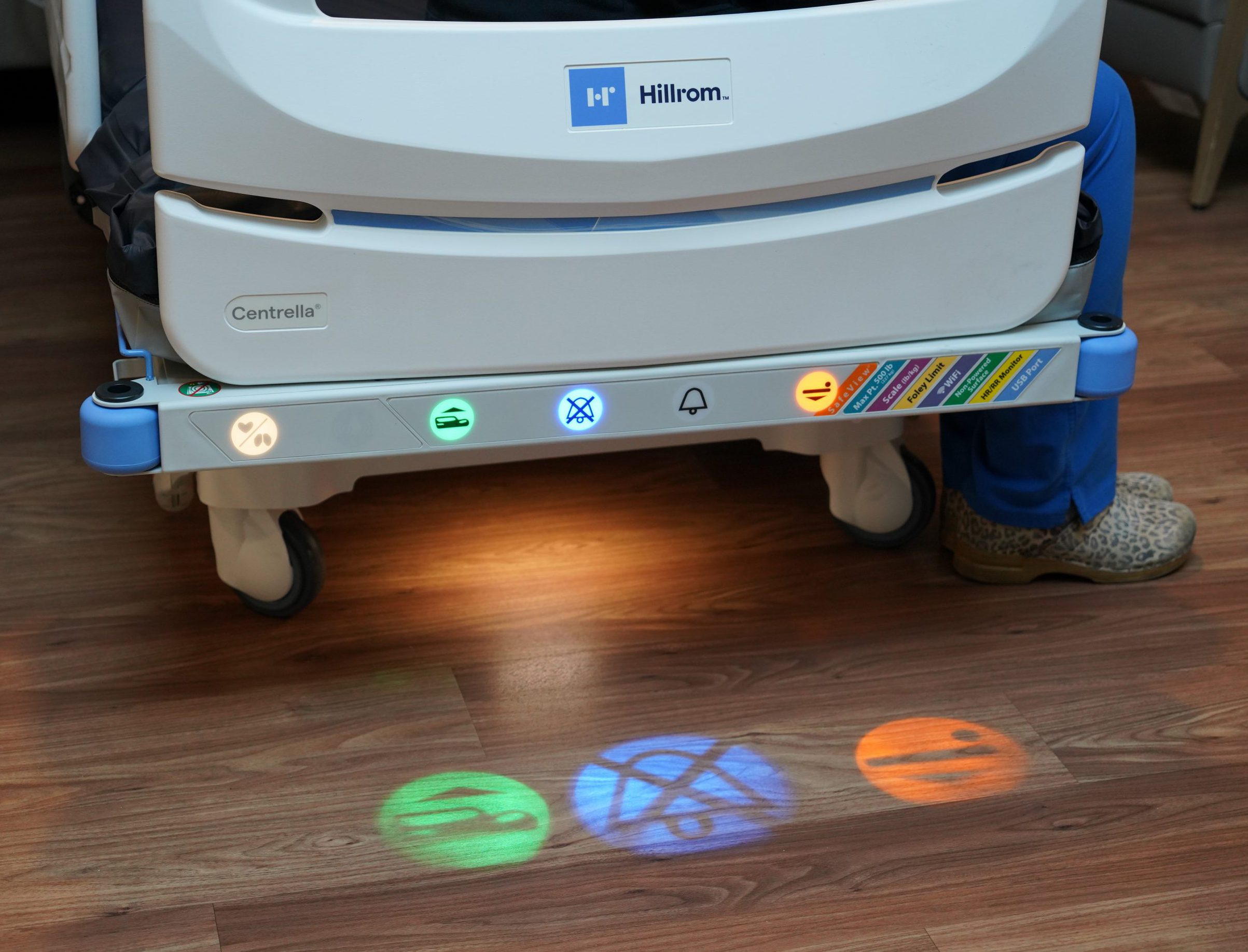 Hospital bed with display light settings that project on the floor