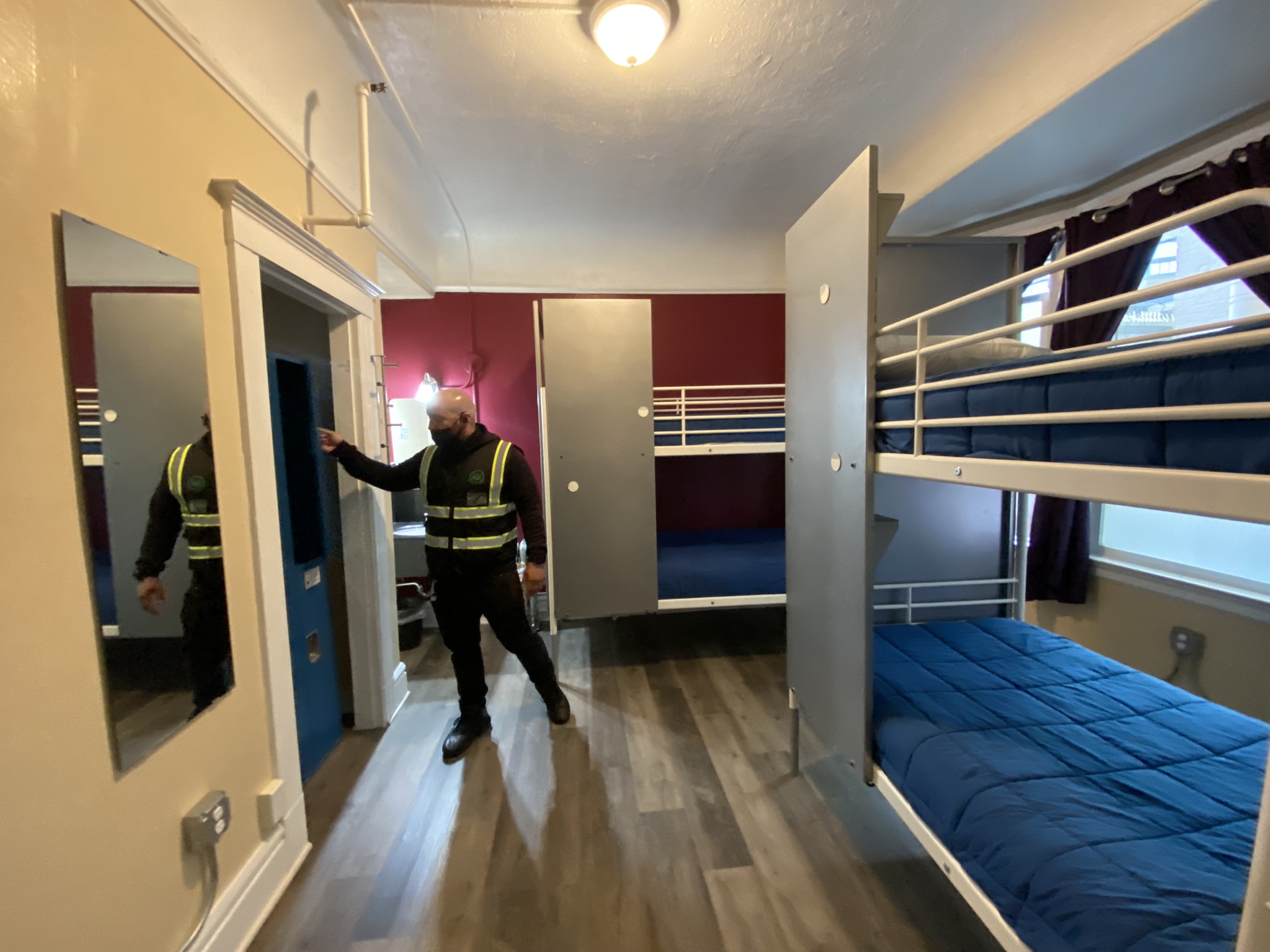 Urban Alchemy staff member shows off a quad room inside 711 Post St., San Francisco's new 260-bed shelter