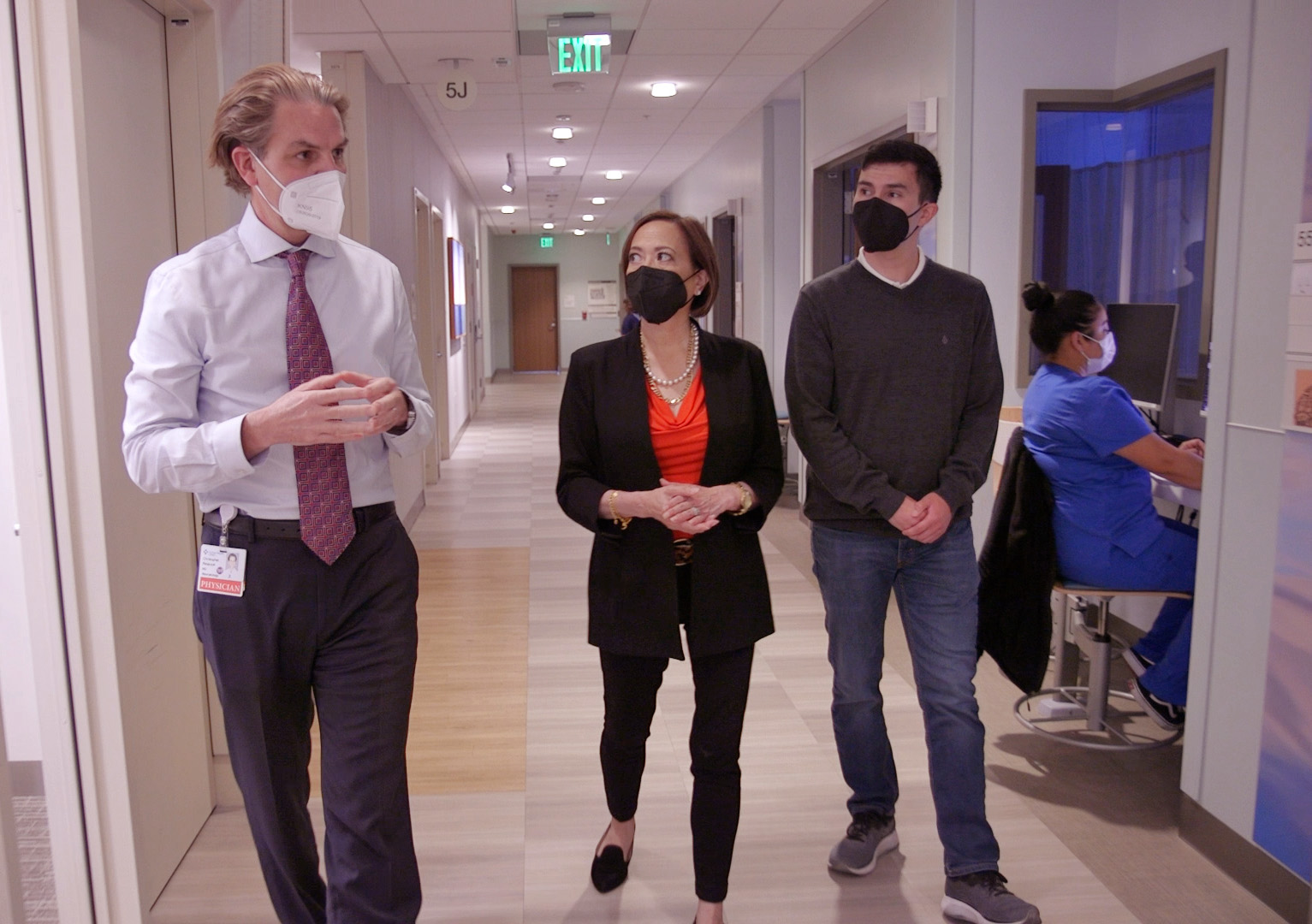 Dr. Christopher Retajczyk, Michele McCarthy and Zach McCarthy walk down the hallway of Sutter CPMC's neonatal intensive care unit.