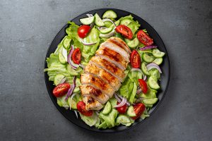 Mediterranean grilled chicken salad with lettuce, tomatoes and cucumbers