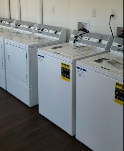 Laundry machines lining up against the wall