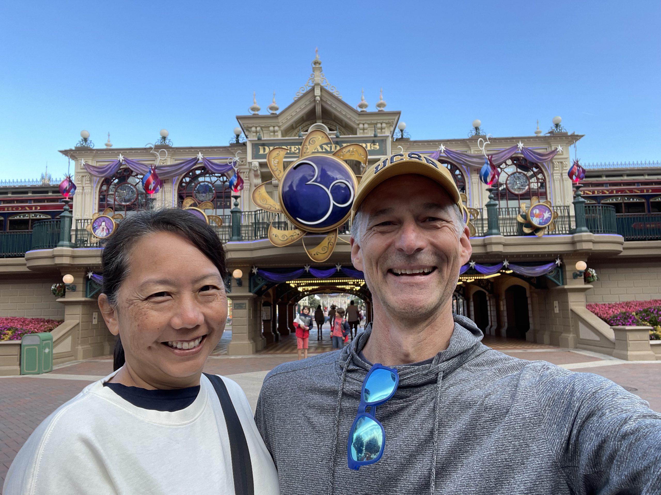 Kari and Brian Jeffs pose in front of Disneyland