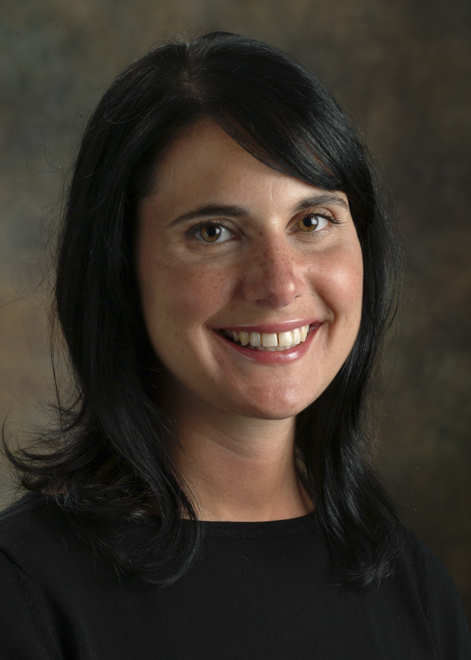 Professional photograph of Dr. Nobl Barazangi, a Caucasian woman with dark hair who is wearing a black blouse. 