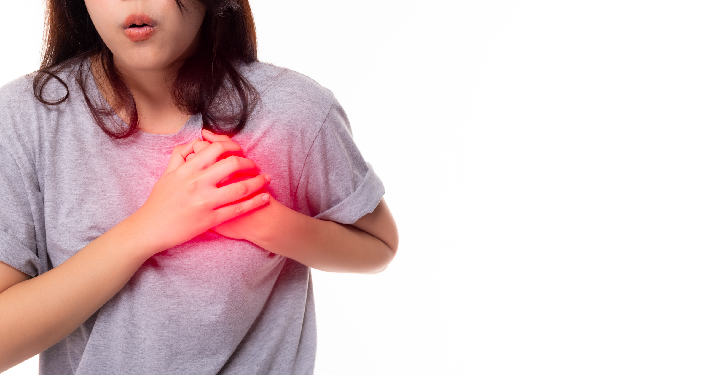 Young woman clutching chest in pain
