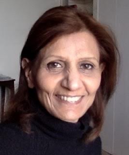 Middle eastern woman in black turtleneck smiling