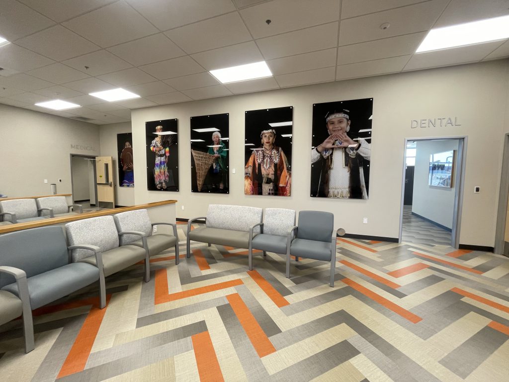 Community clinic lobby with Native American artwork and doors leading to medical and dental exam rooms