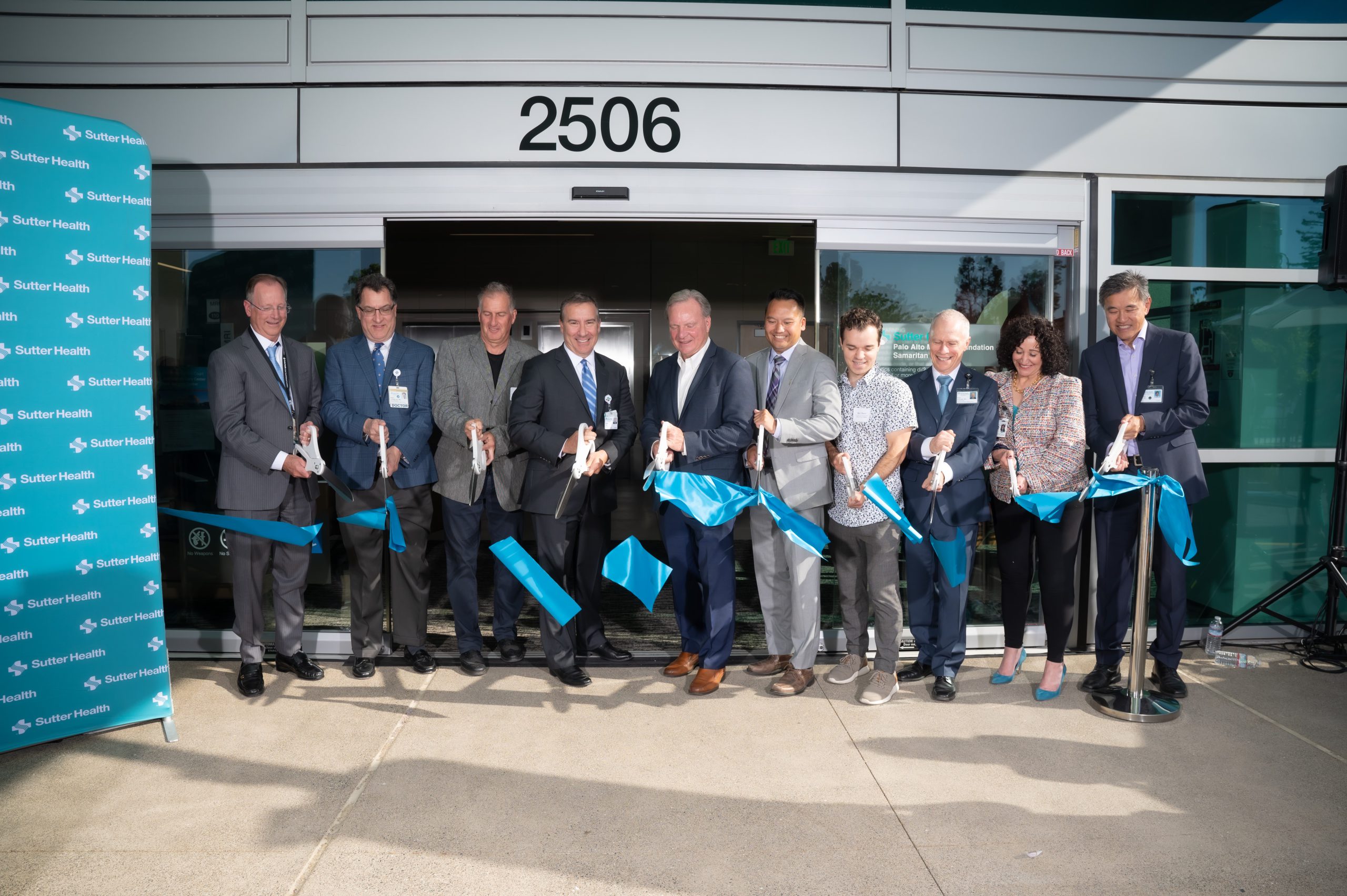 Photo of Sutter Health leaders cutting a ribbon in front of 2506 Samaritan Court
