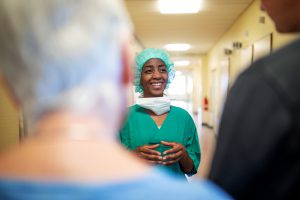 Female surgeon talking to a people at hospital