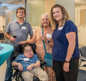 Four adults pose for picture while at social event honoring new clinic space