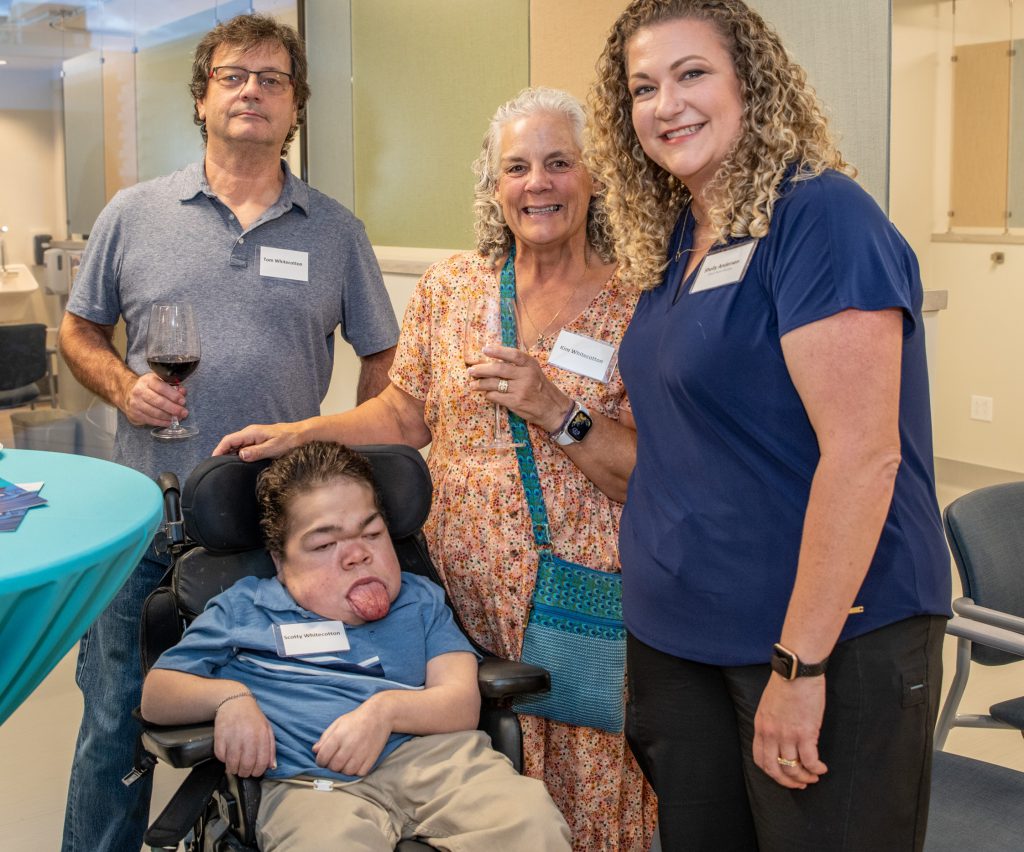 Four adults pose for picture while at social event honoring new clinic space