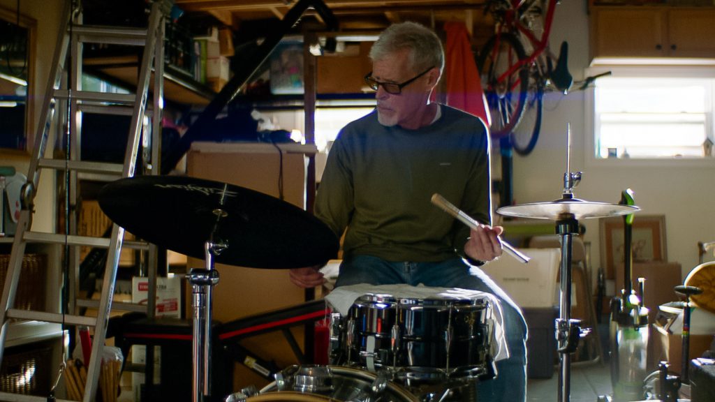 Drummer in garage with drum kit