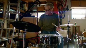 Drummer in garage with drum kit
