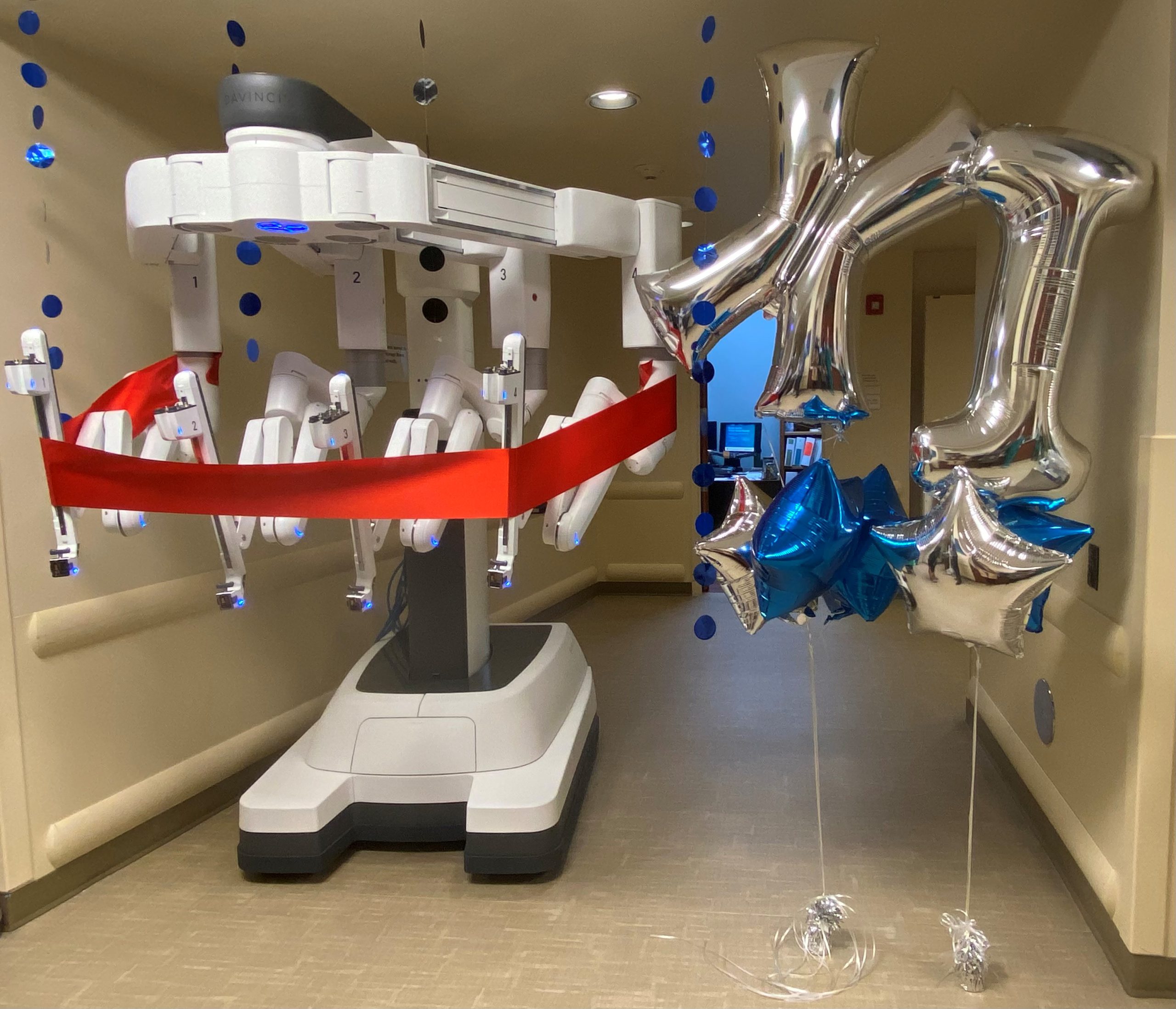 The new da Vinci Xi surgical robot with a red ribbon around its frame