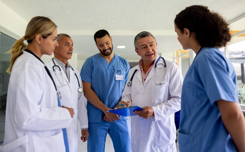 Group of doctors talking inside a hospital hallway