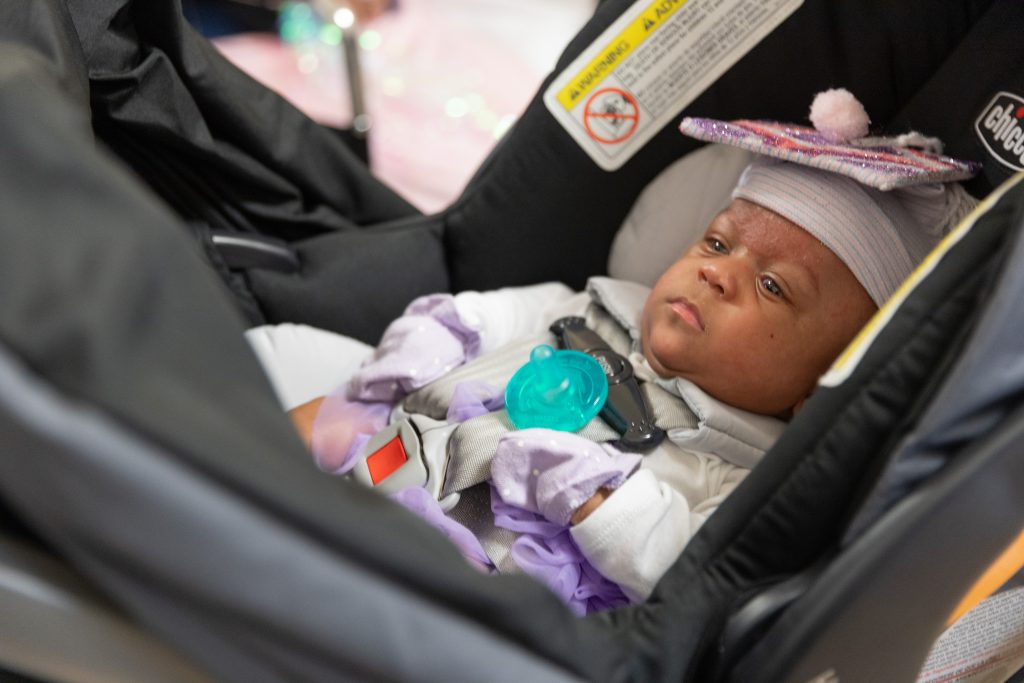 Micropremie Seiori Sweeney Austin, wearing her NICU graduation 'mortar board,' leaves the Alta Bates Summit Medical Center for the first time since she was born six months ago.