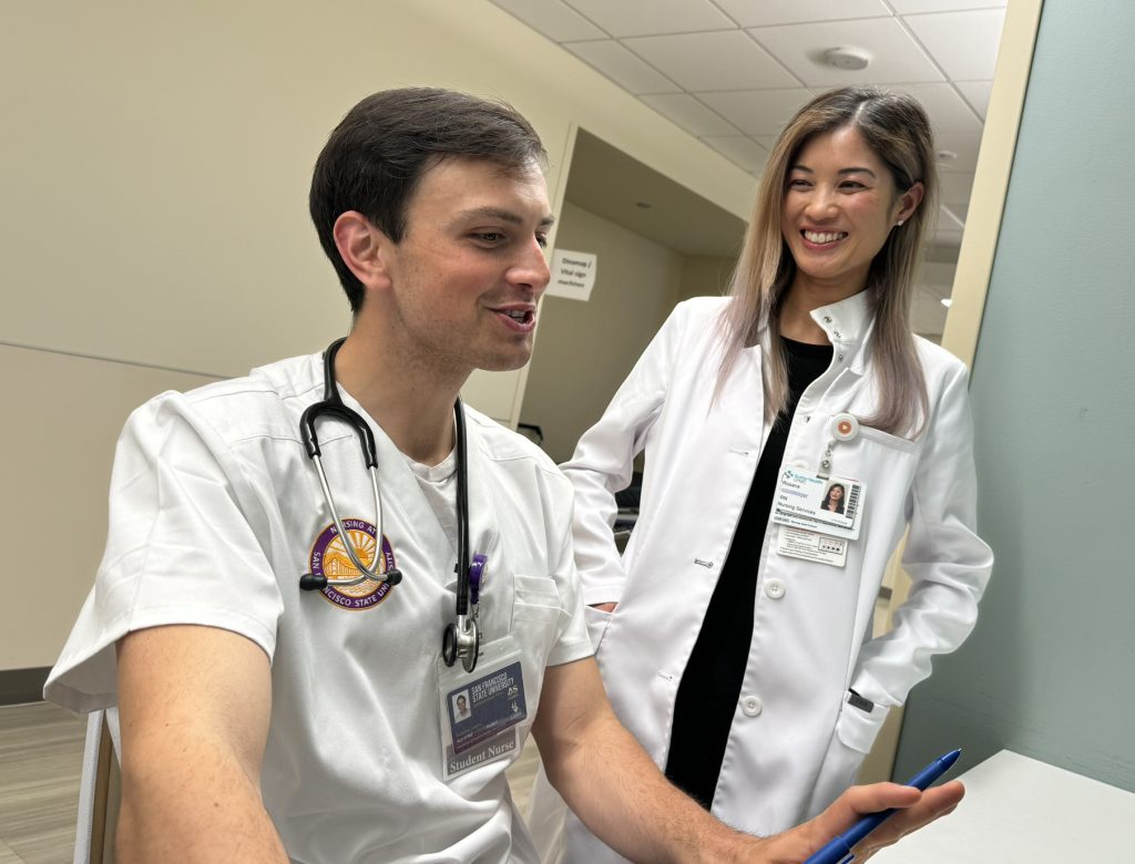 A nursing student talks with a clinical nurse instructor
