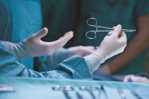 Surgeon holding a pair of scissors