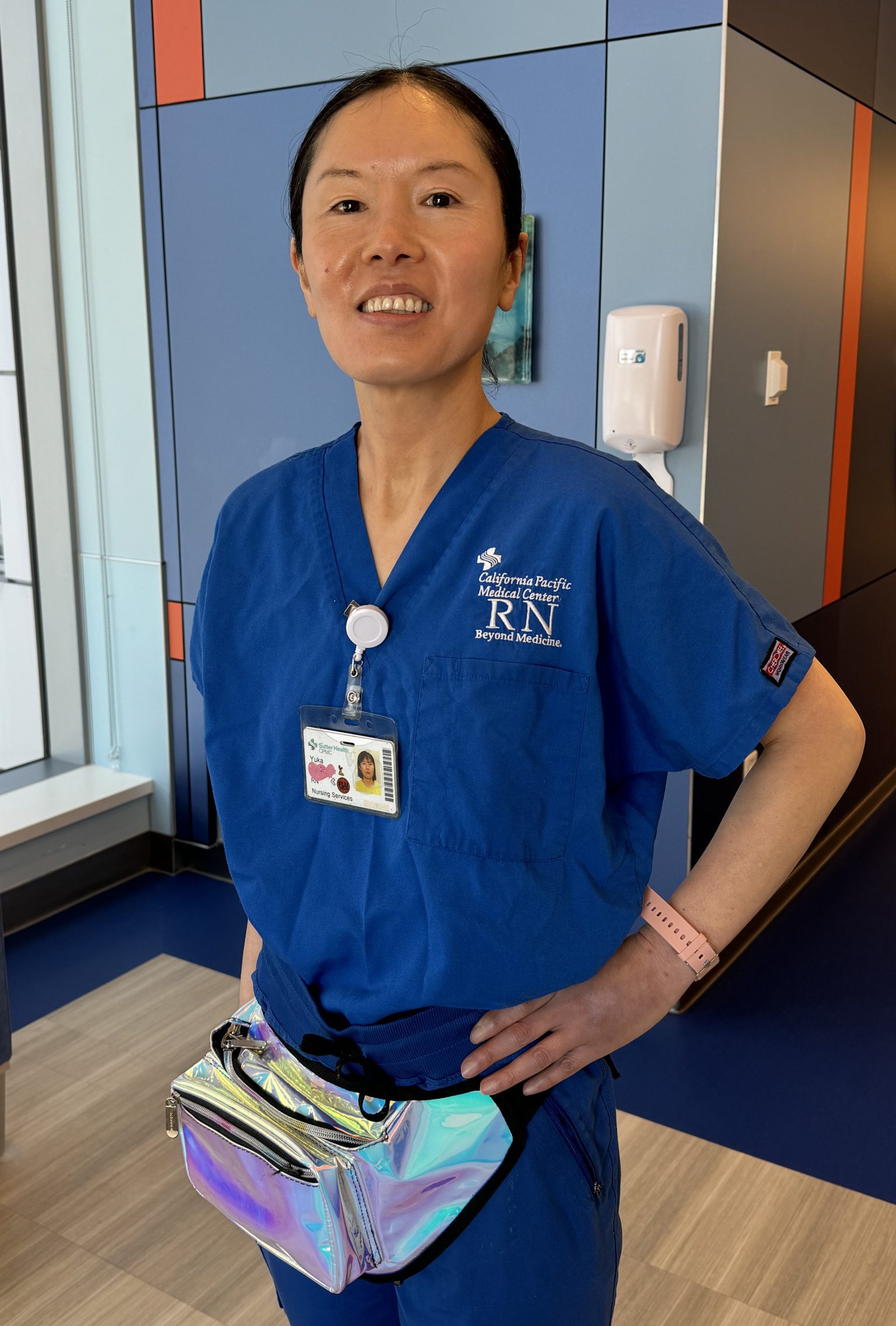 Asian nurse in blue scrubs