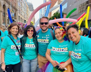 People at Pride parade in San Francisco wearing teal Sutter Health shirts.