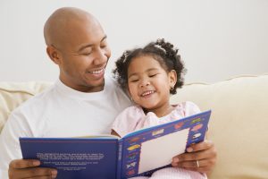 Indian father reading to daughter