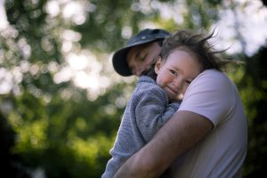 Dad hugs toddler son