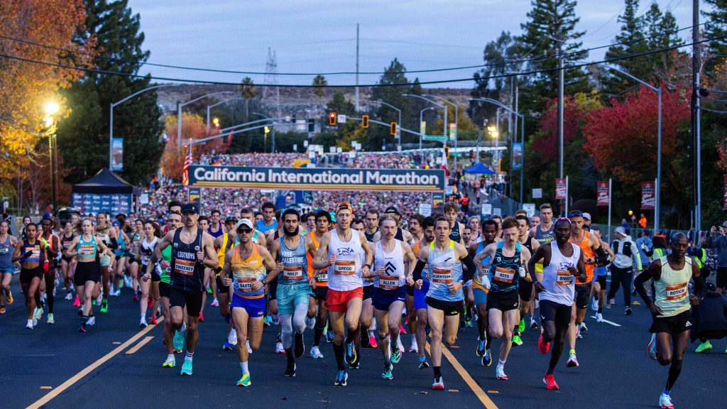 Hundreds of runners fill the streets for a marathon in the early morning hours